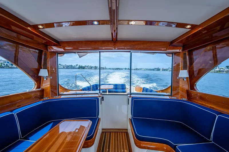 Slide: The Image of Luxurious interior of 2021 Hinckley Talaria 43 Motoryacht with elegant wood finish and blue seating. - 13