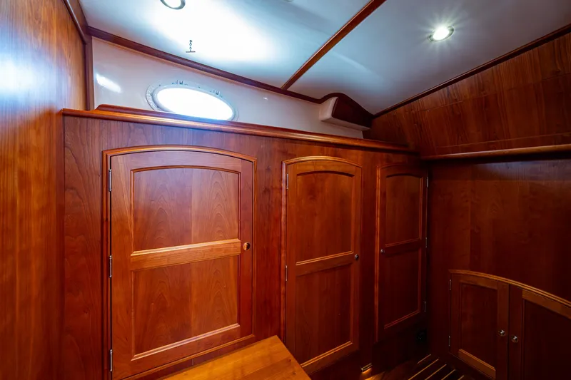 Slide: The Image of Luxurious wooden interior of 2021 Hinckley Talaria 43 Motoryacht cabin with elegant cabinetry. - 19