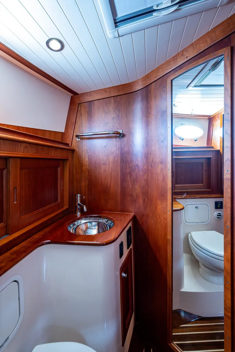 Slide: The Image of Luxurious 2021 Hinckley Talaria 43 Motoryacht bathroom with wood accents and modern fixtures. - 22