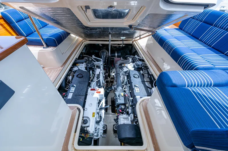 Slide: The Image of Engine compartment of 2021 Hinckley Talaria 43 Motoryacht with blue-striped seating. - 35