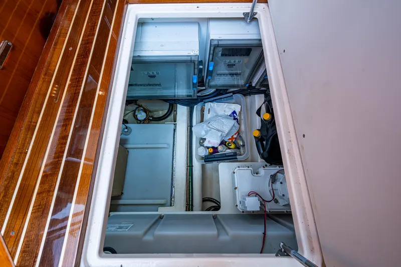 Slide: The Image of Engine compartment of 2021 Hinckley Talaria 43 Motoryacht, showcasing storage and mechanical components. - 38