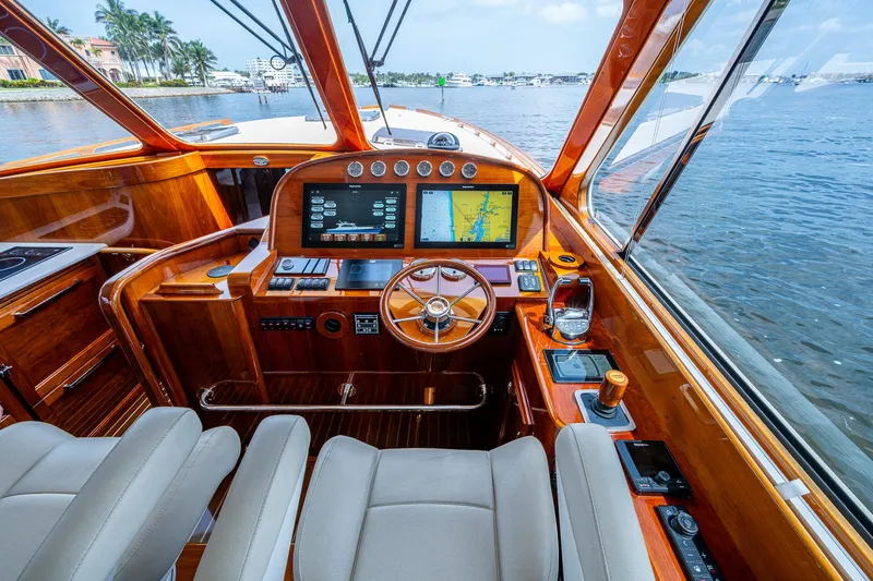 Slide: The Image of Interior of 2021 Hinckley Talaria 43 Motoryacht with luxurious wooden helm and navigation screens. - 4