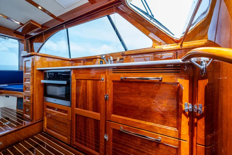 Slide: The Image of Luxurious interior of 2021 Hinckley Talaria 43 Motoryacht with polished wood cabinetry. - 10