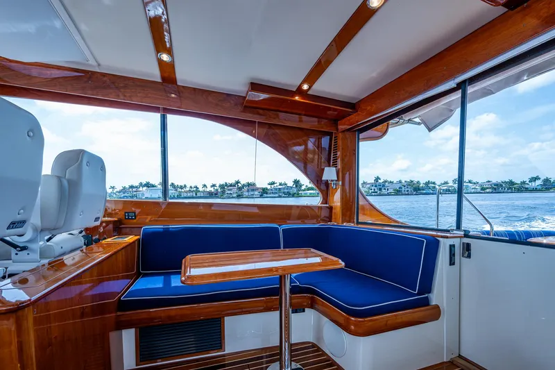 Slide: The Image of Luxurious interior of 2021 Hinckley Talaria 43 Motoryacht with blue seating and wooden accents. - 14