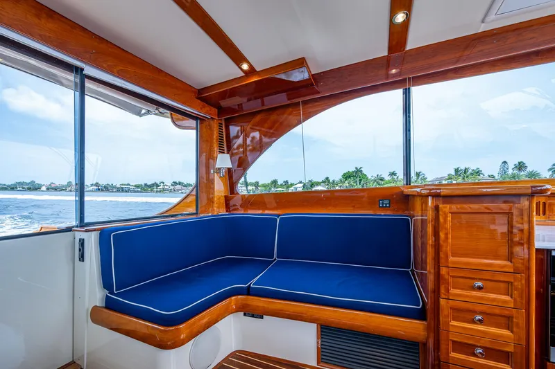 Slide: The Image of Luxurious interior of 2021 Hinckley Talaria 43 Motoryacht with blue seating and wooden finish. - 15