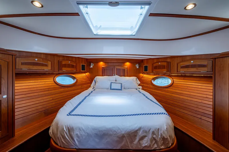 Slide: The Image of Luxurious cabin interior of 2021 Hinckley Talaria 43 Motoryacht with wood paneling and skylight. - 16