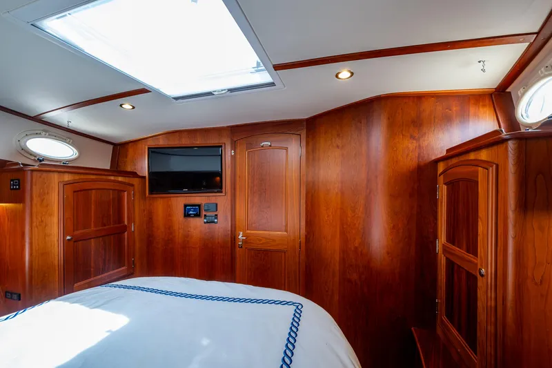 Slide: The Image of Luxurious wood interior of 2021 Hinckley Talaria 43 Motoryacht cabin with skylight and TV. - 17