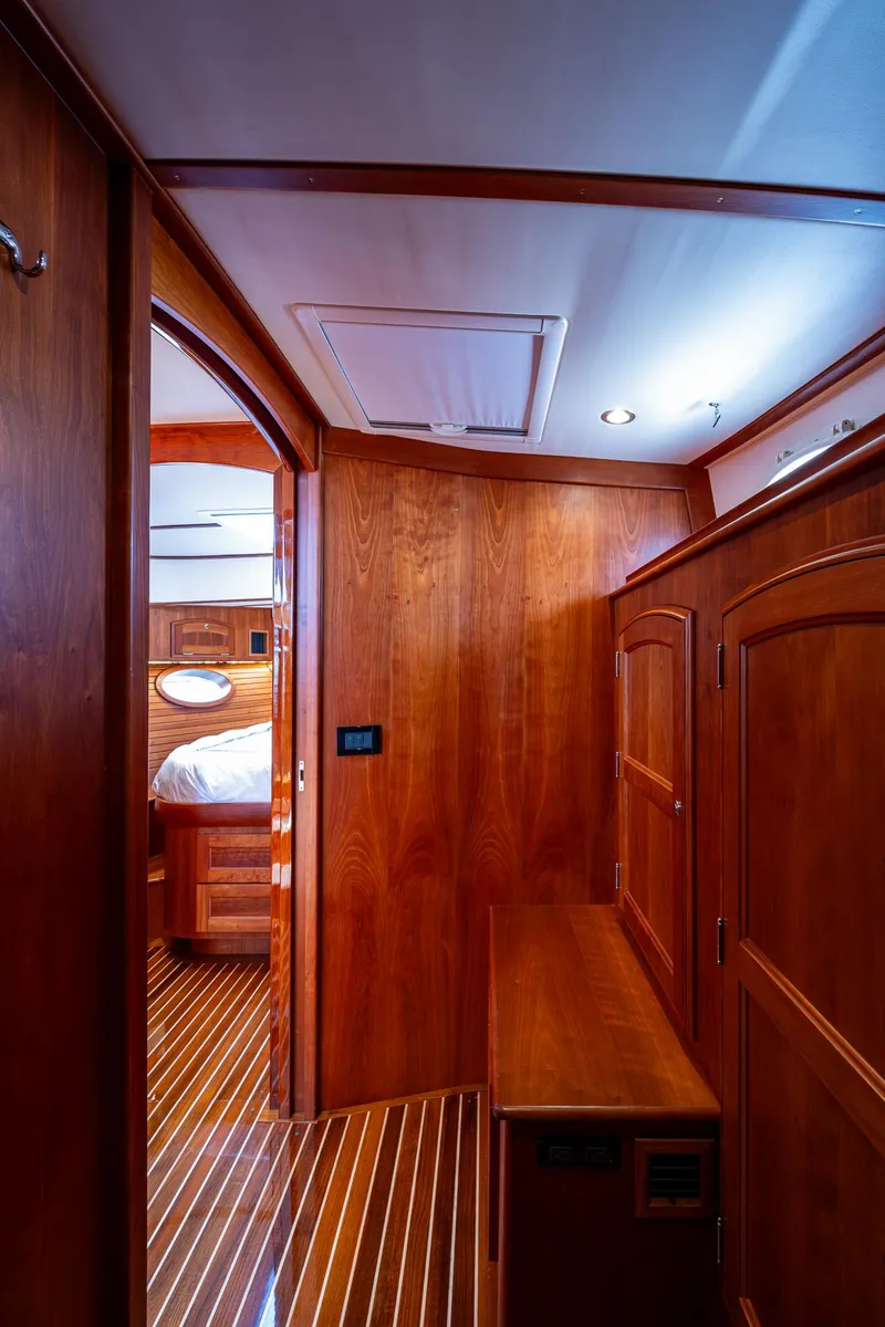 Slide: The Image of Interior of 2021 Hinckley Talaria 43 Motoryacht, featuring elegant wood paneling and cabinetry. - 21
