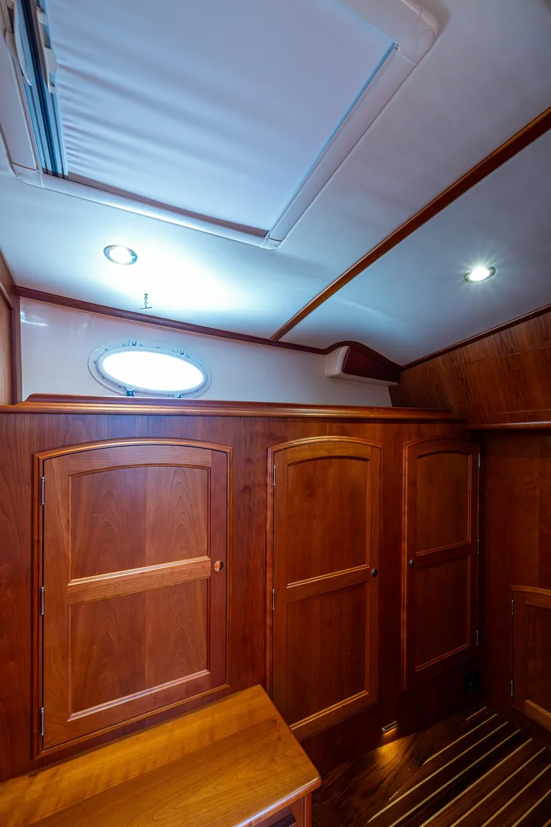 Slide: The Image of Interior of 2021 Hinckley Talaria 43 Motoryacht with wooden cabinetry and ceiling lights. - 23