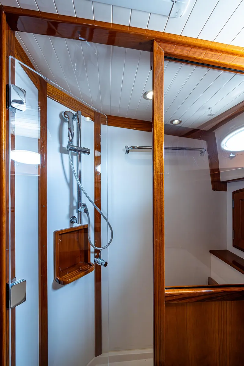 Slide: The Image of Luxurious shower in 2021 Hinckley Talaria 43 Motoryacht with wood accents and modern fixtures. - 26