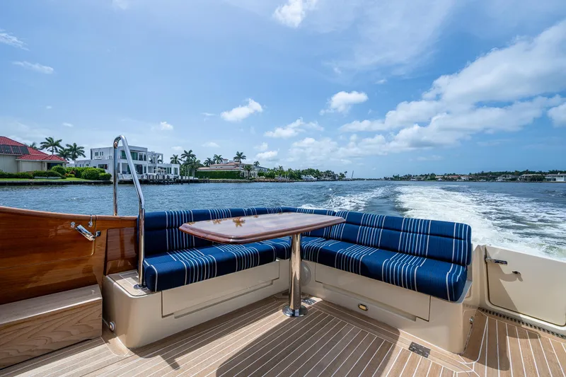 Slide: The Image of Hinckley Talaria 43 Motoryacht 2021, elegant seating area with waterfront view. - 27