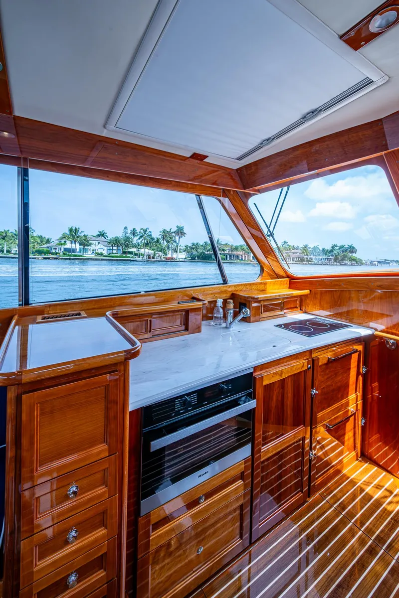 Slide: The Image of Interior of 2021 Hinckley Talaria 43 Motoryacht with elegant wood finish and modern kitchen amenities. - 7