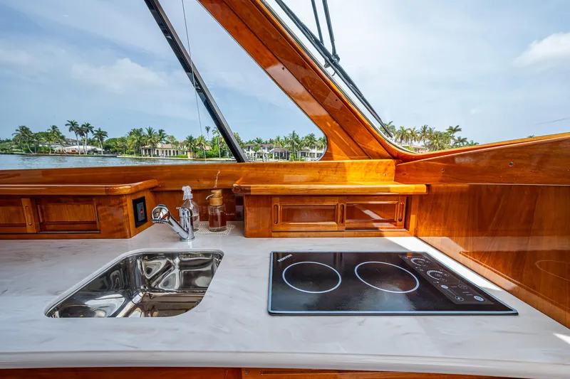 Slide: The Image of Luxurious 2021 Hinckley Talaria 43 Motoryacht interior with sleek kitchen and scenic view. - 9