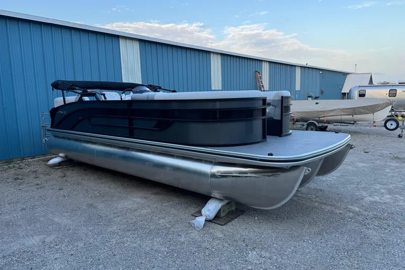 The Image of 2025 Lowe SS230WV pontoon boat on water with two people relaxing onboard. - 0