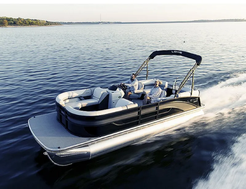 Slide: The Image of 2025 Lowe SS230WV pontoon boat interior with seating and steering console in a marina setting. - 5
