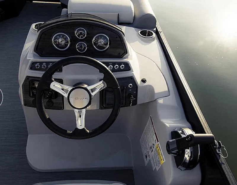 Slide: The Image of 2025 Lowe SS230WV pontoon boat cruising on a serene lake. - 6