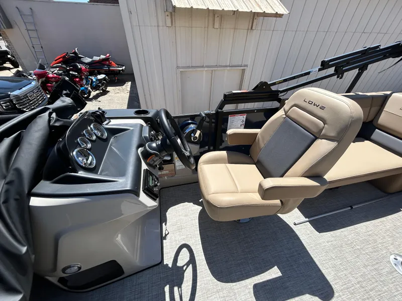 Slide: The Image of Steering wheel and dashboard of 2025 Lowe LS210WT boat, featuring modern controls and design. - 3
