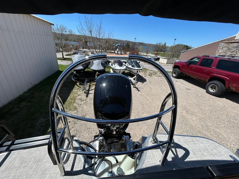 Slide: The Image of 2025 Lowe LS210WT boat interior with beige captain's chair and control panel. - 4