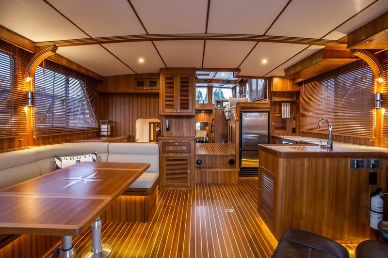 Slide: The Image of Luxurious interior of 2026 Helmsman Trawlers 43E Pilothouse with wood finishes and modern amenities. - 18