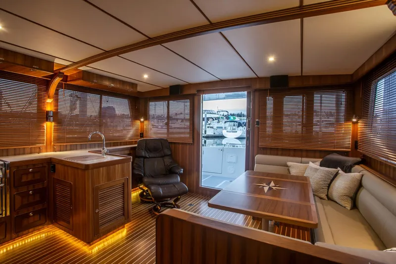 Slide: The Image of Luxurious interior of 2026 Helmsman Trawlers 43E Pilothouse with wood accents and modern seating. - 19