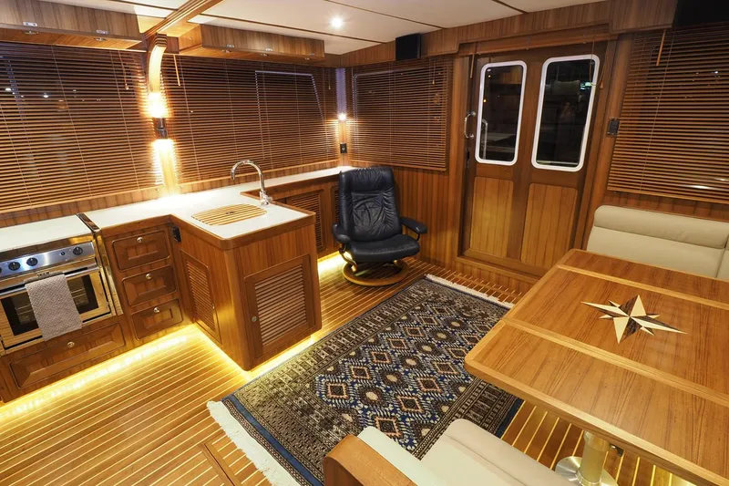 Slide: The Image of Luxurious interior of 2026 Helmsman Trawlers 43E Pilothouse with wood finish and elegant furnishings. - 24