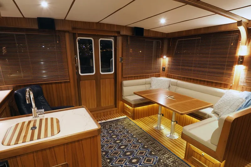 Slide: The Image of Luxurious interior of 2026 Helmsman Trawlers 43E PILOTHOUSE with wood finish and cozy seating. - 25