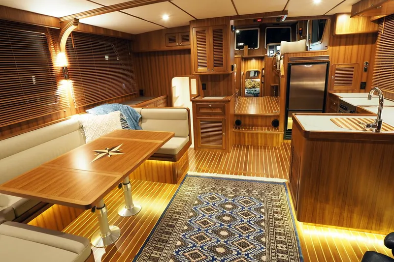 Slide: The Image of Luxurious interior of 2026 Helmsman Trawlers 43E PILOTHOUSE with wood finishes and modern amenities. - 26