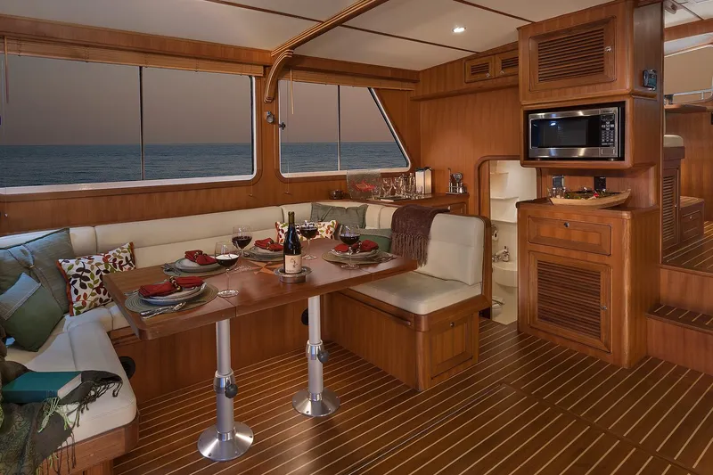 Slide: The Image of Luxurious interior of 2026 Helmsman Trawlers 43E Pilothouse with elegant dining setup. - 29
