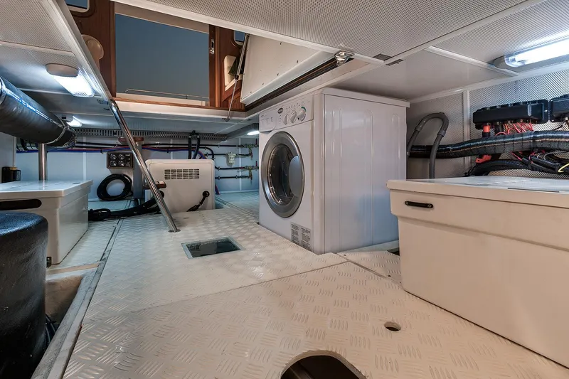 Slide: The Image of Engine room of 2026 Helmsman Trawlers 43E PILOTHOUSE with washer and storage. - 40