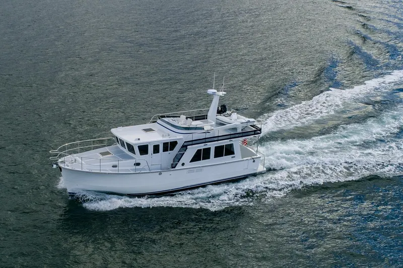 Slide: The Image of 2026 Helmsman Trawlers 43E Pilothouse cruising on open water. - 6