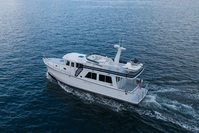 Slide: The Image of 2026 Helmsman Trawlers 43E Pilothouse cruising on open water. - 7