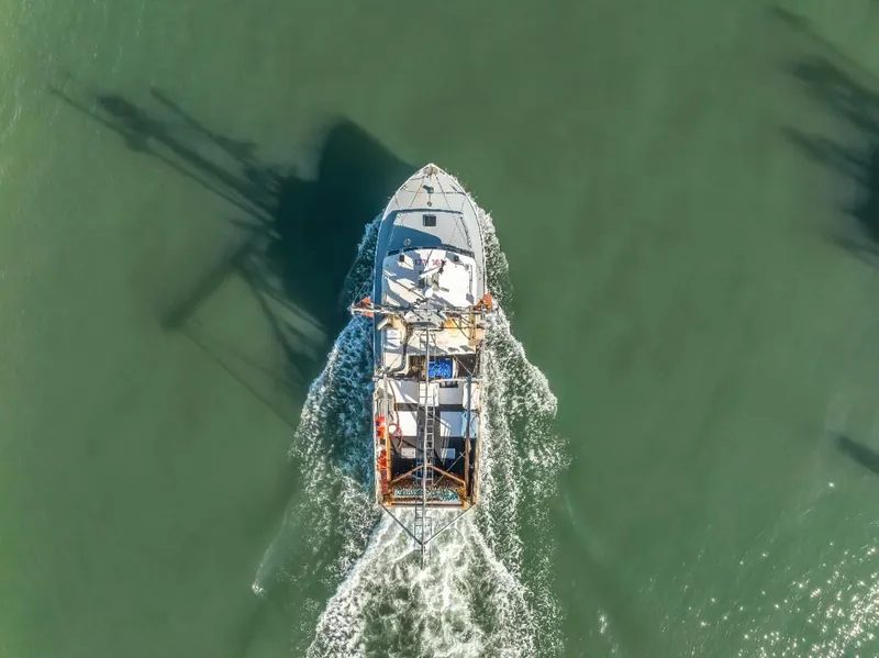 Slide: The Image of Aerial view of 2015 Wesmac commercial fishing vessel navigating through green waters. - 4
