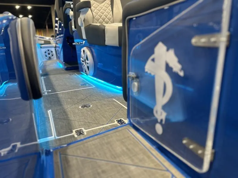 Slide: The Image of 2025 Statement 350 Open Center Console interior with blue LED lighting and luxury seating. - 10