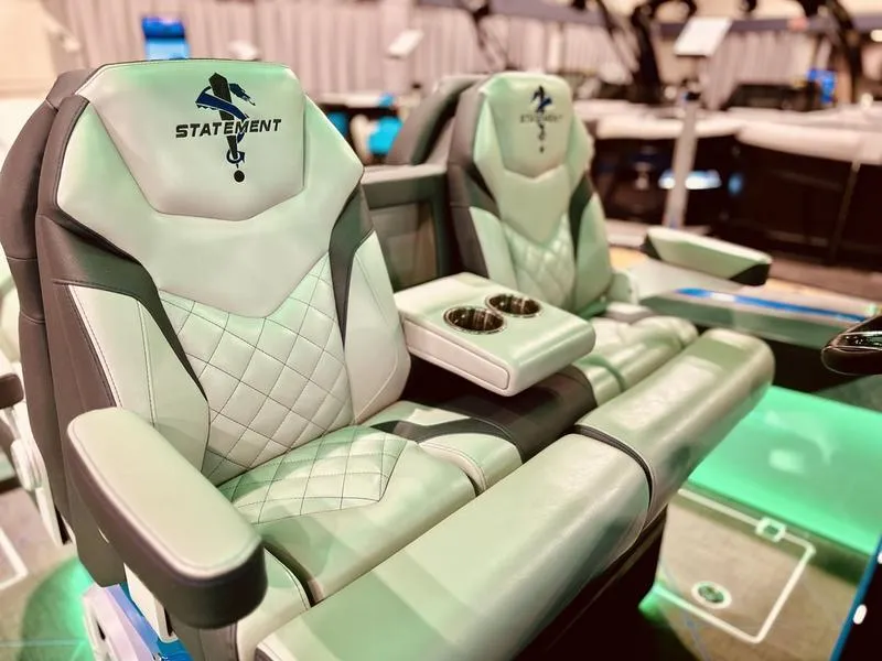 Slide: The Image of 2025 Statement 350 Open Center Console luxury seating with cup holders and quilted design. - 11