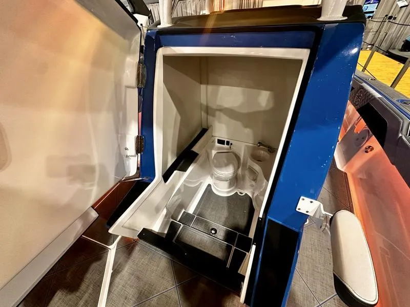 Slide: The Image of 2025 Statement 350 Open Center Console boat interior with compact restroom. - 21