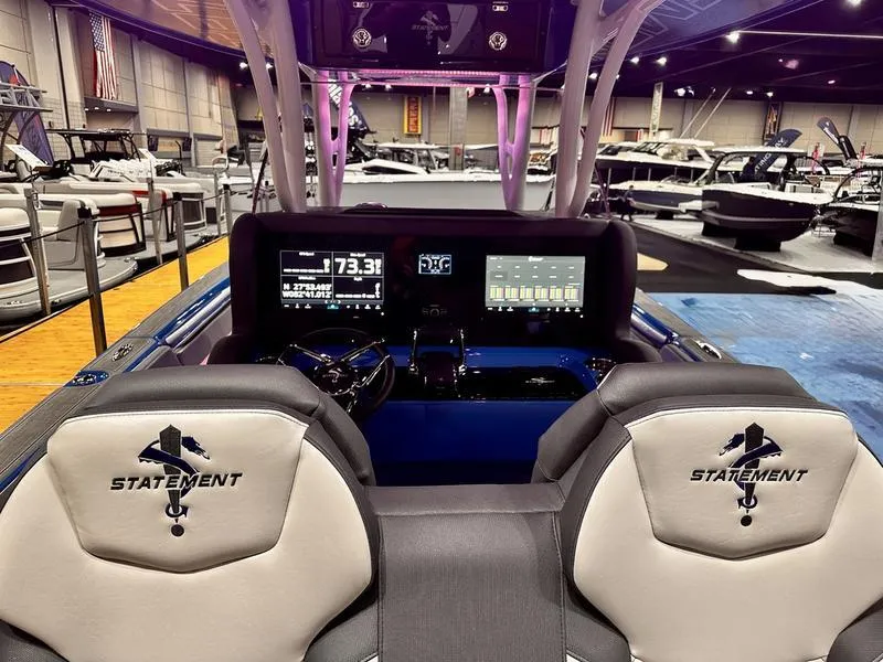 Slide: The Image of 2025 Statement 350 Open Center Console boat interior with dual screens and branded seating. - 23