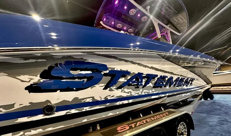 Slide: The Image of 2025 Statement 350 Open Center Console boat with sleek blue and white design. - 7