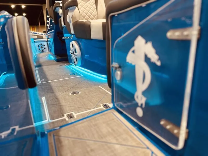 Slide: The Image of 2025 Statement 350 Open Center Console interior with blue LED lighting and seahorse design. - 8