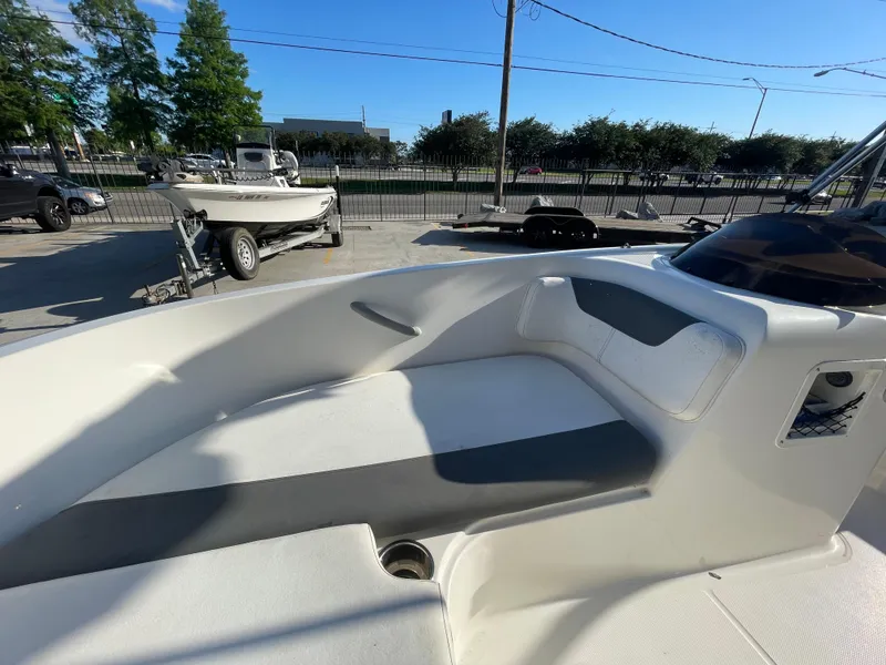 Slide: The Image of 2017 Bayliner Element E16 boat interior with seating, parked outdoors. - 10