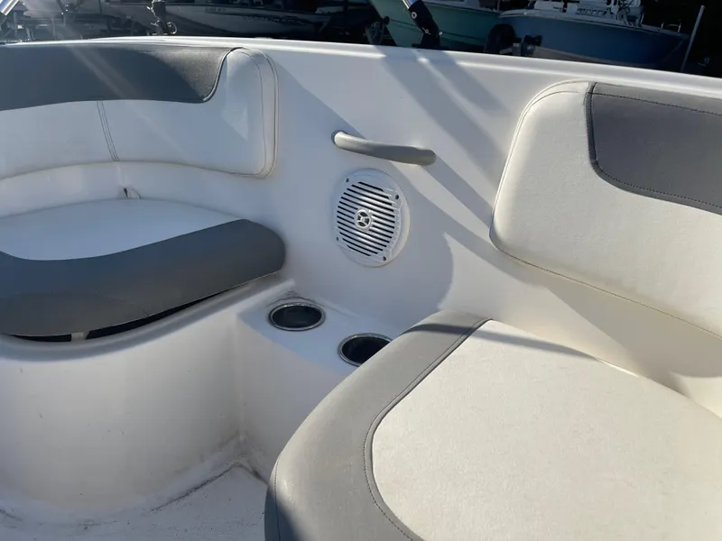 Slide: The Image of 2017 Bayliner Element E16 boat interior with cushioned seating and cup holders. - 11