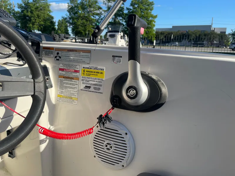 Slide: The Image of 2017 Bayliner Element E16 boat controls with throttle, steering wheel, and safety instructions. - 15