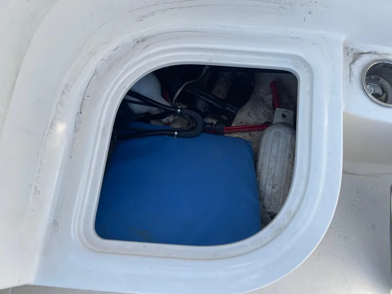 Slide: The Image of Storage compartment of 2017 Bayliner Element E16 boat with blue container and cables. - 20