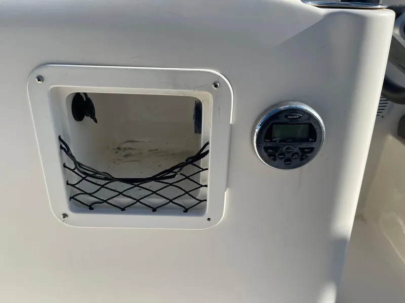 Slide: The Image of 2017 Bayliner Element E16 dashboard with storage compartment and audio control panel. - 22