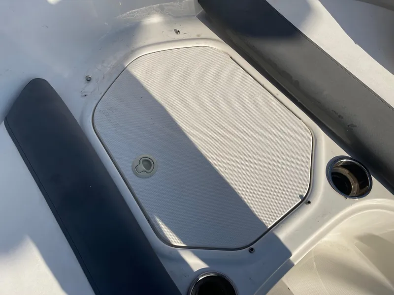 Slide: The Image of 2017 Bayliner Element E16 boat interior with storage compartment and cup holders. - 24