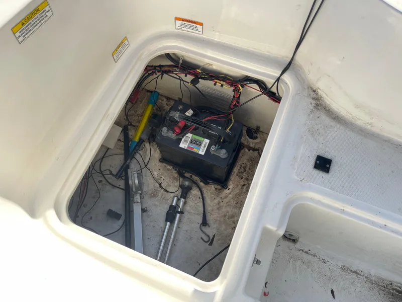 Slide: The Image of 2017 Bayliner Element E16 battery compartment with wiring and tools visible. - 27