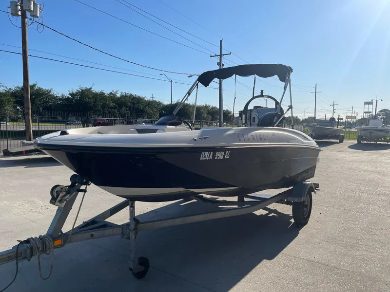 Slide: The Image of 2017 Bayliner Element E16 boat on trailer in sunny outdoor setting. - 4
