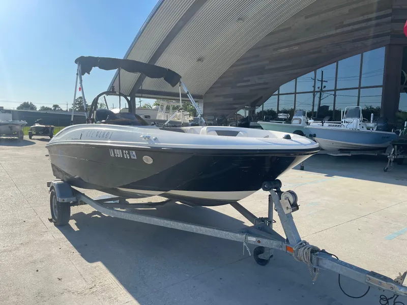 Slide: The Image of 2017 Bayliner Element E16 boat on trailer, parked outdoors. - 6