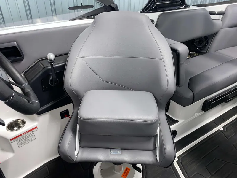Slide: The Image of 2025 Moomba Max boat interior with gray captain's seat and control panel. - 11