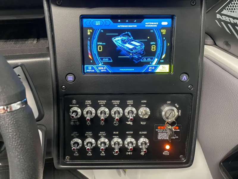Slide: The Image of 2025 Moomba Max dashboard with digital display and control switches. - 13