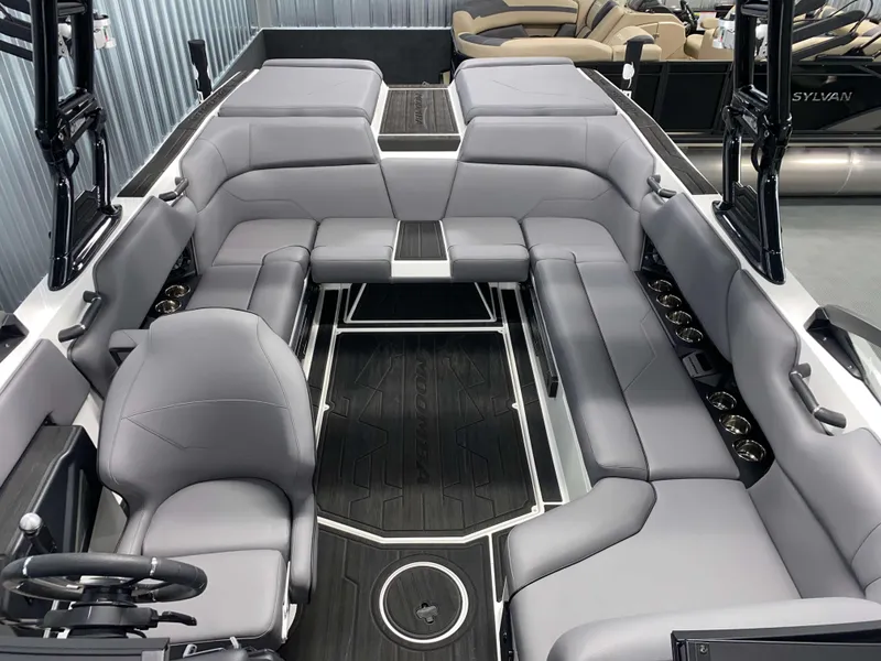 Slide: The Image of 2025 Moomba Max boat interior with gray seating and black flooring. - 14